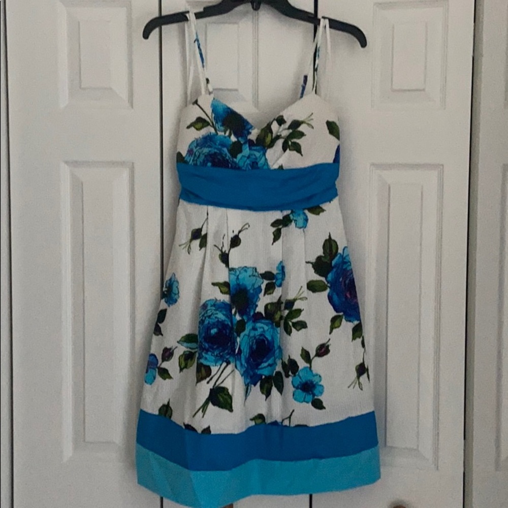 White dress with blue colored flowers